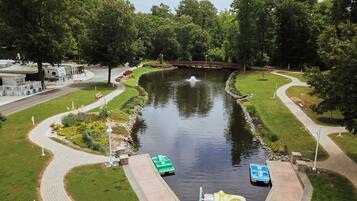 A park with a pond, walking paths, and boats.