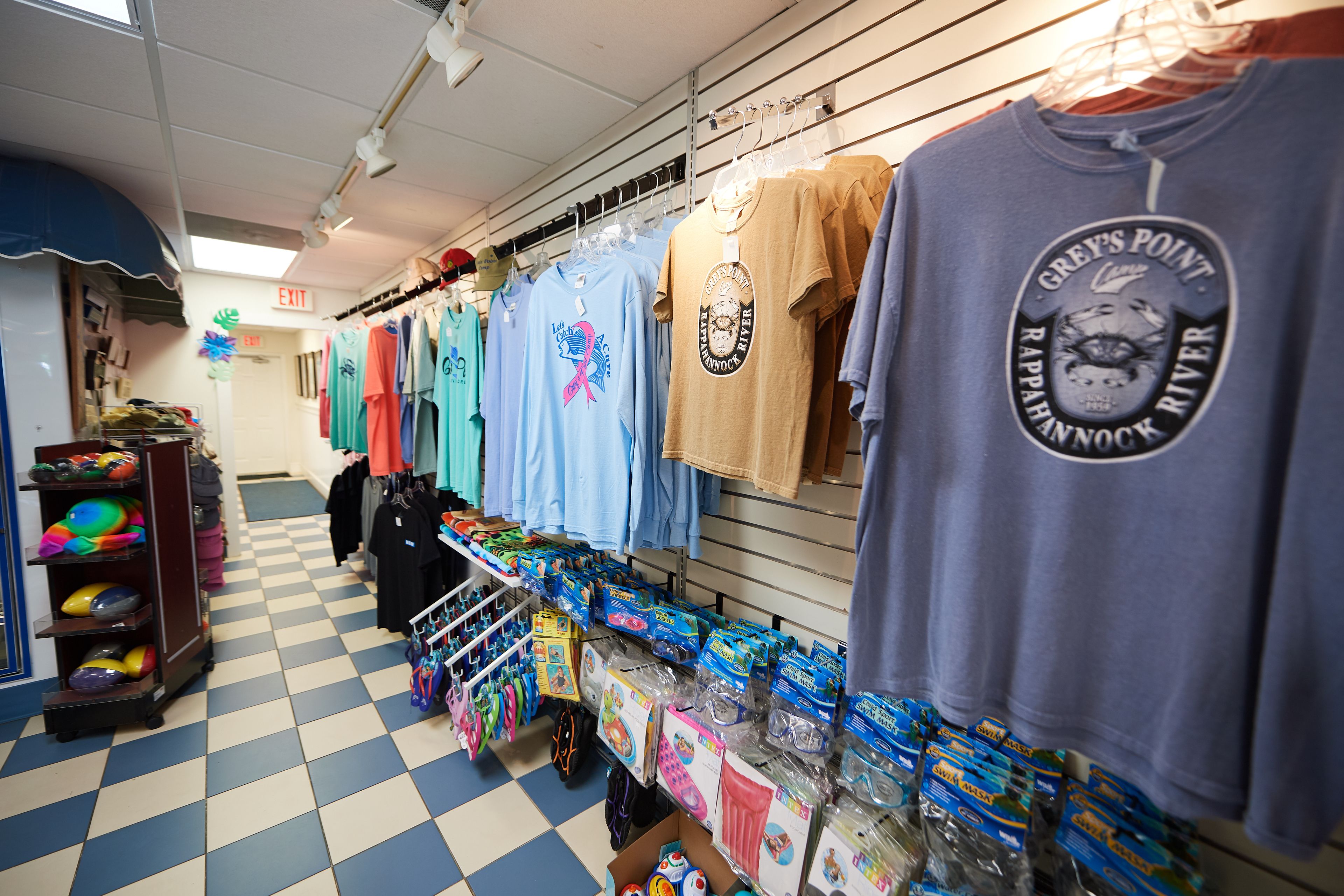 A retail store with various clothing items and accessories on display.