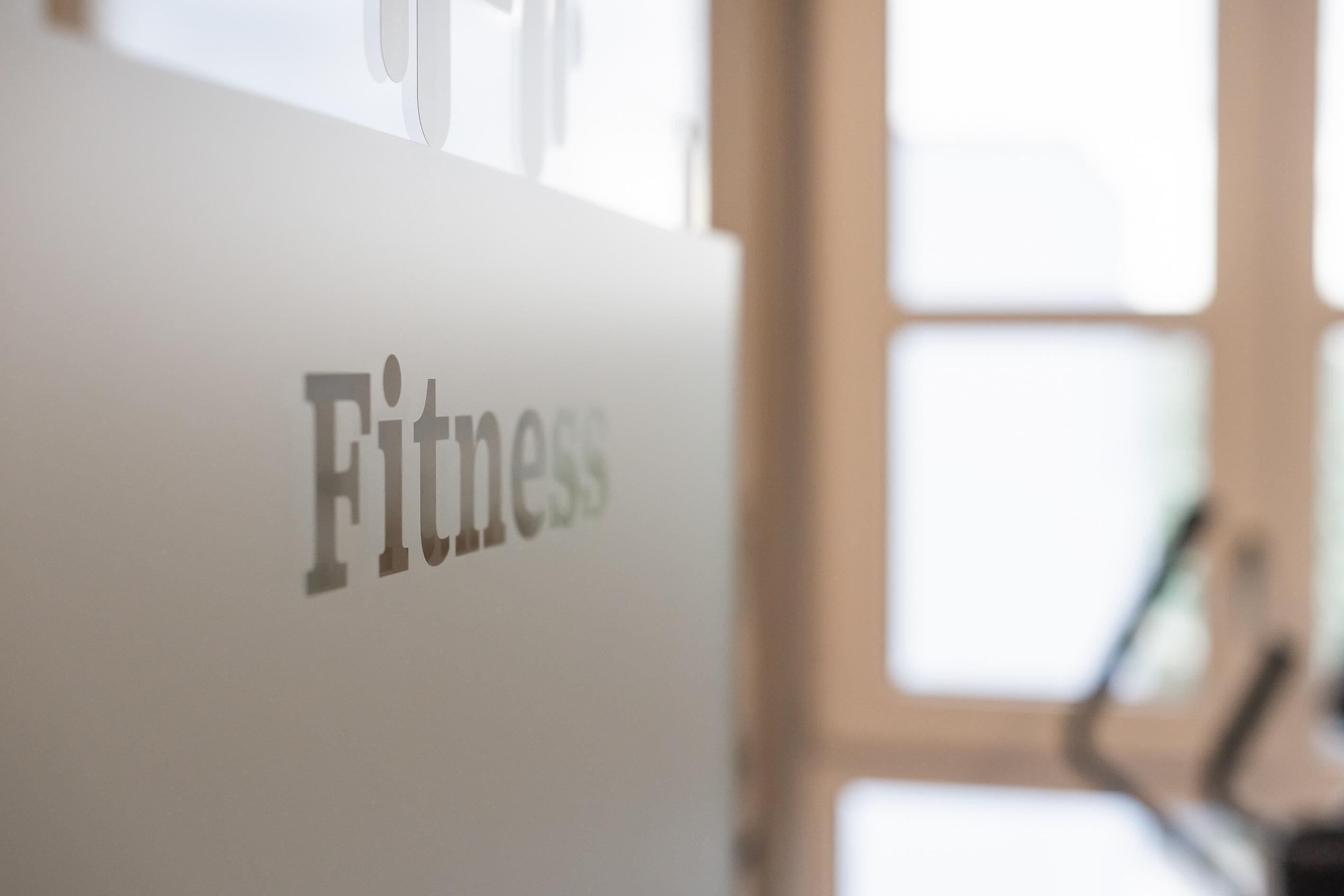 A blurred sign with the word 'Fitness' indicating a fitness area or facility.