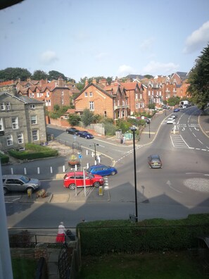 A residential street with houses, parked cars, and a pedestrian crossing. - The Grove (Whitby)
