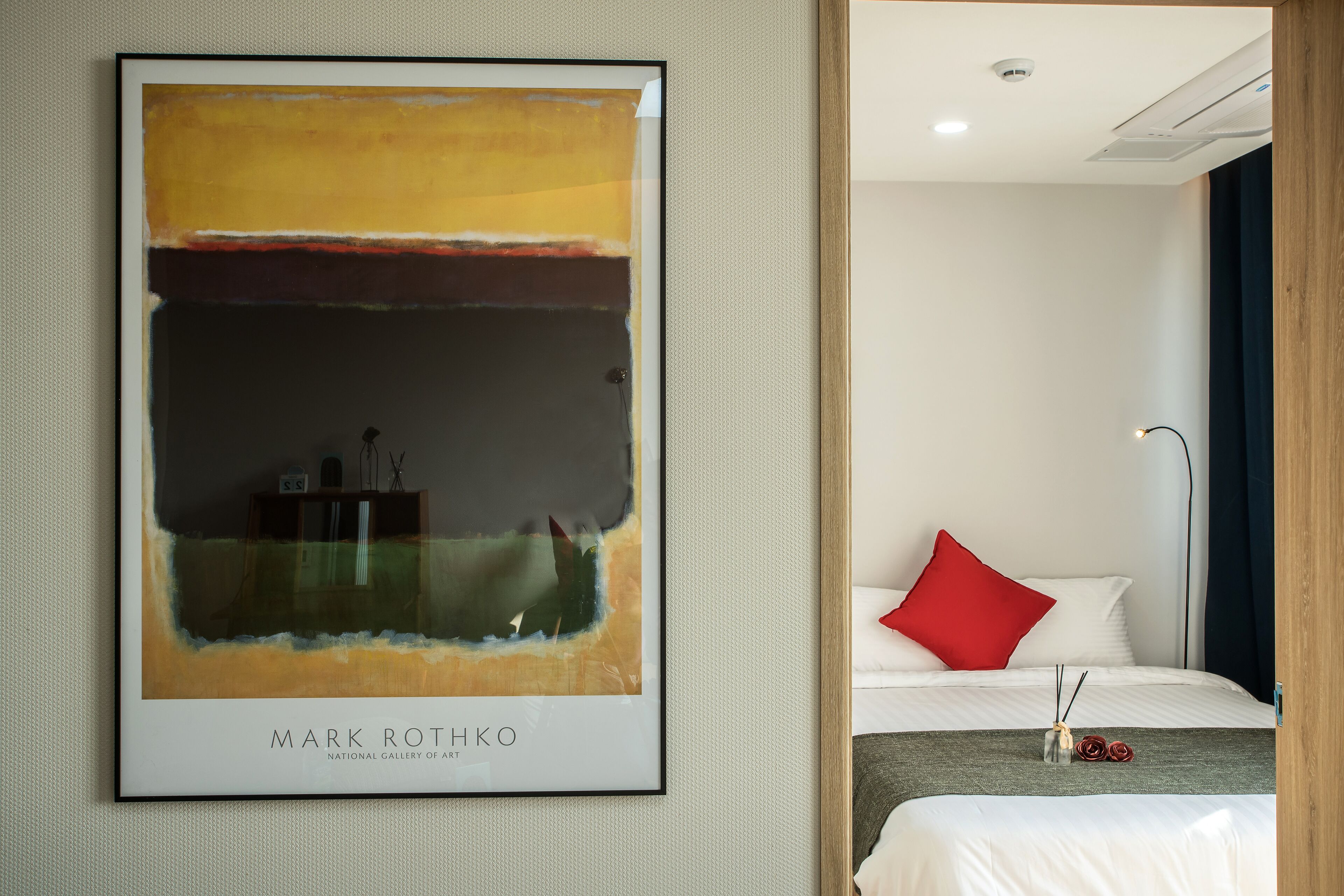 A framed abstract painting by Mark Rothko in a hotel room.