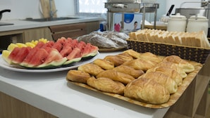 A breakfast buffet with various pastries and sliced watermelon. - D'annam Hostel Hanoi (Hanoi)