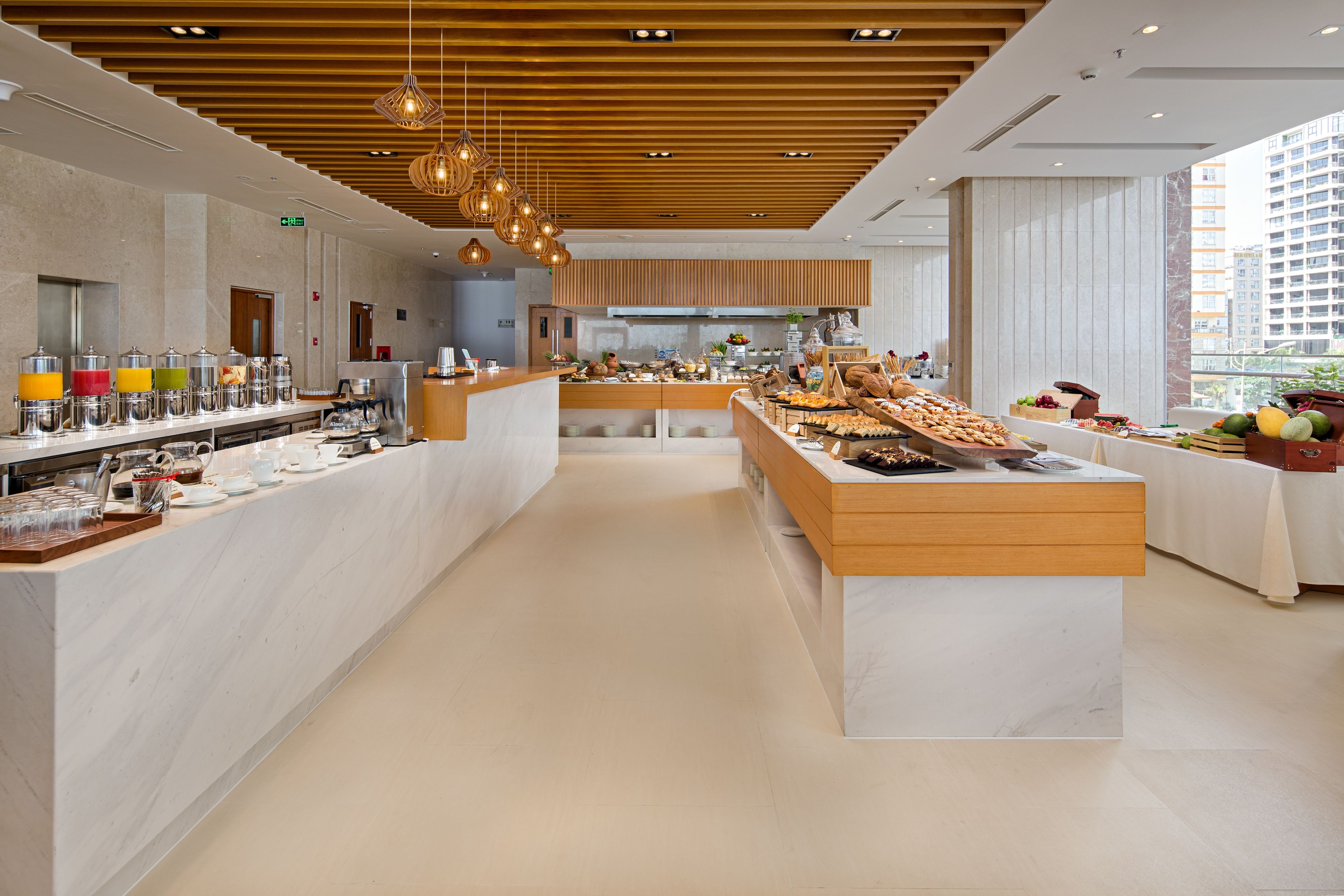 A modern breakfast bar with a variety of food items and beverages.