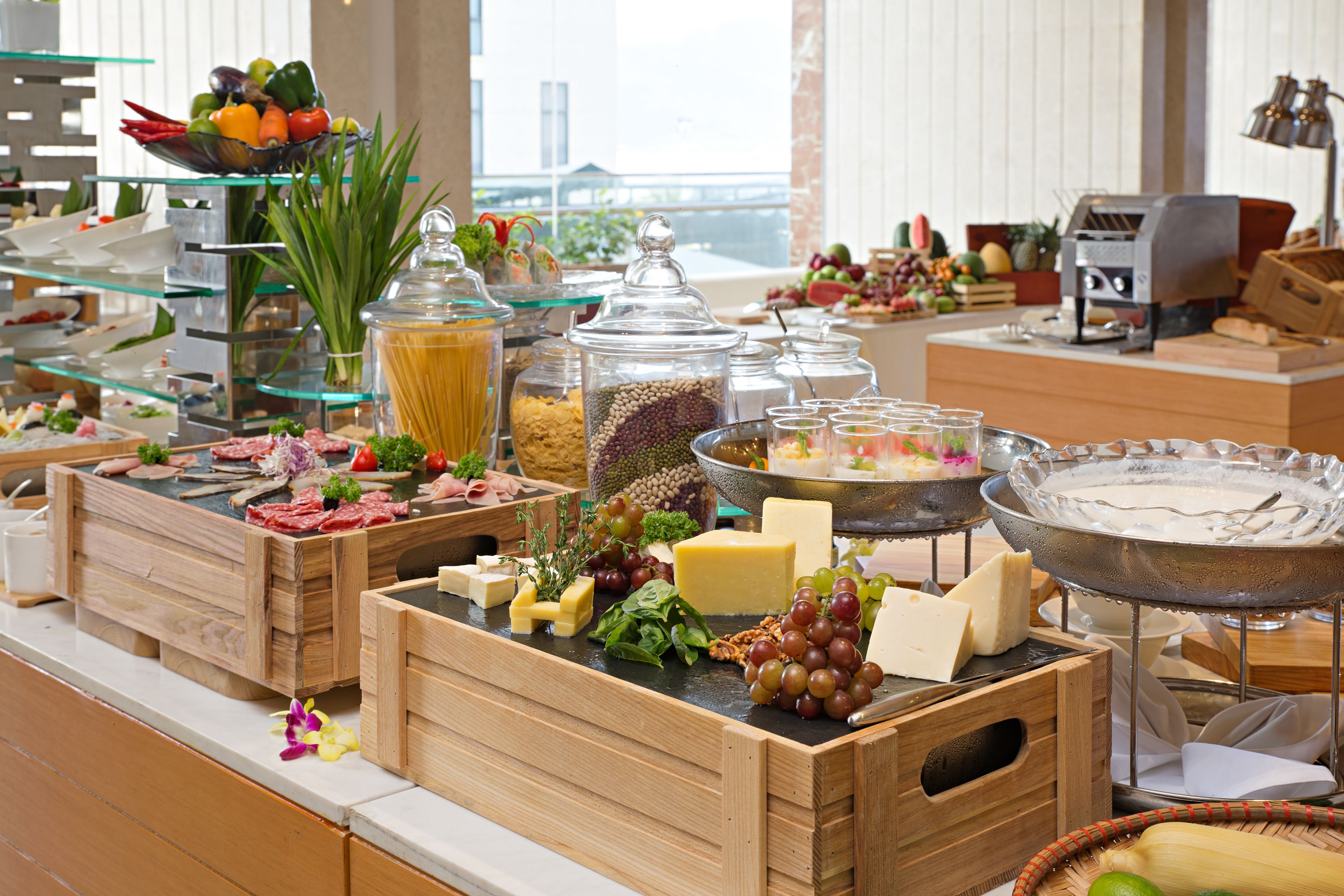 A buffet with various food items and a coffee machine.