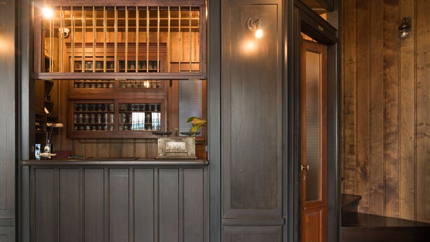 A bar area with wooden cabinets and a counter.