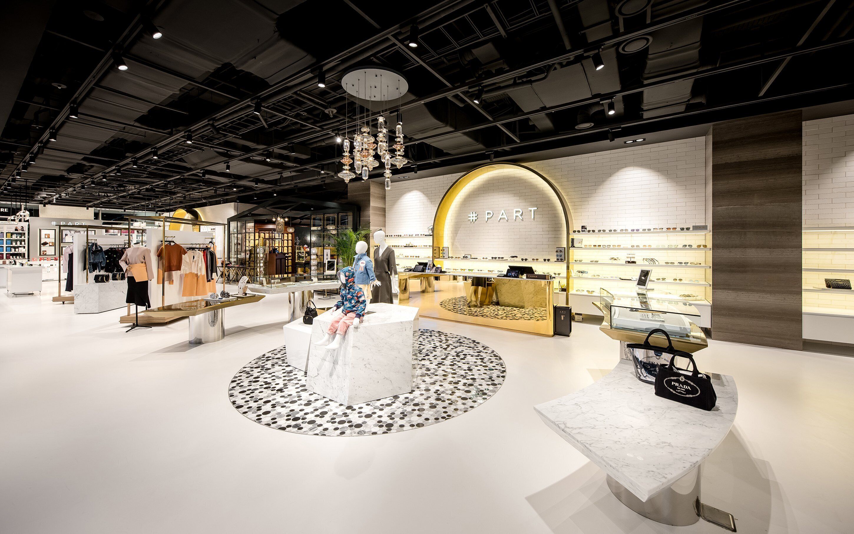 A modern retail store with mannequins displaying clothing and jewelry.