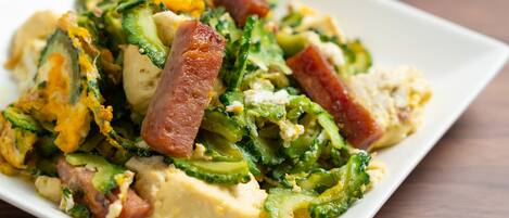 A dish with various vegetables and meat on a white plate.