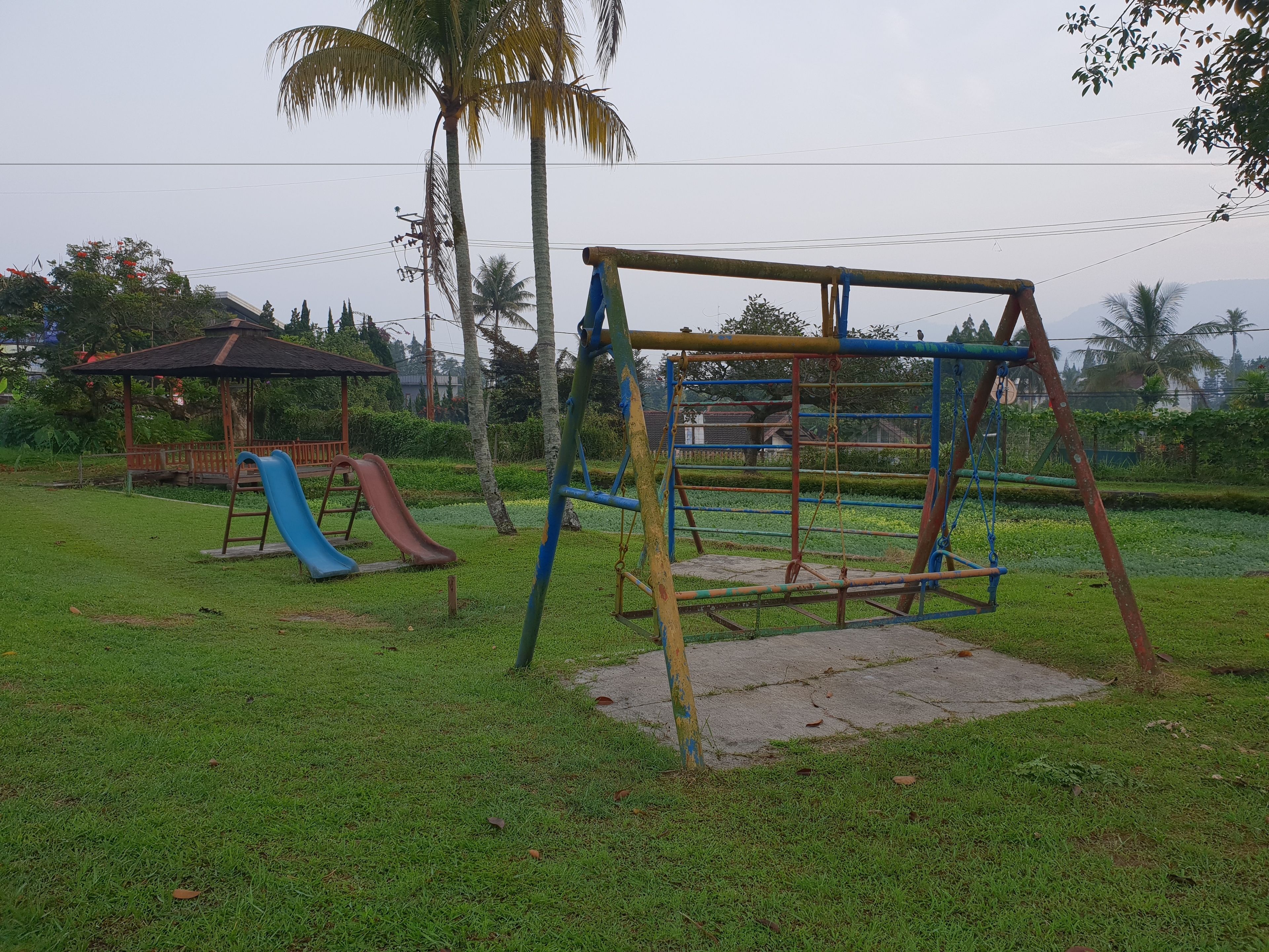 A playground with a swing set and a slide.