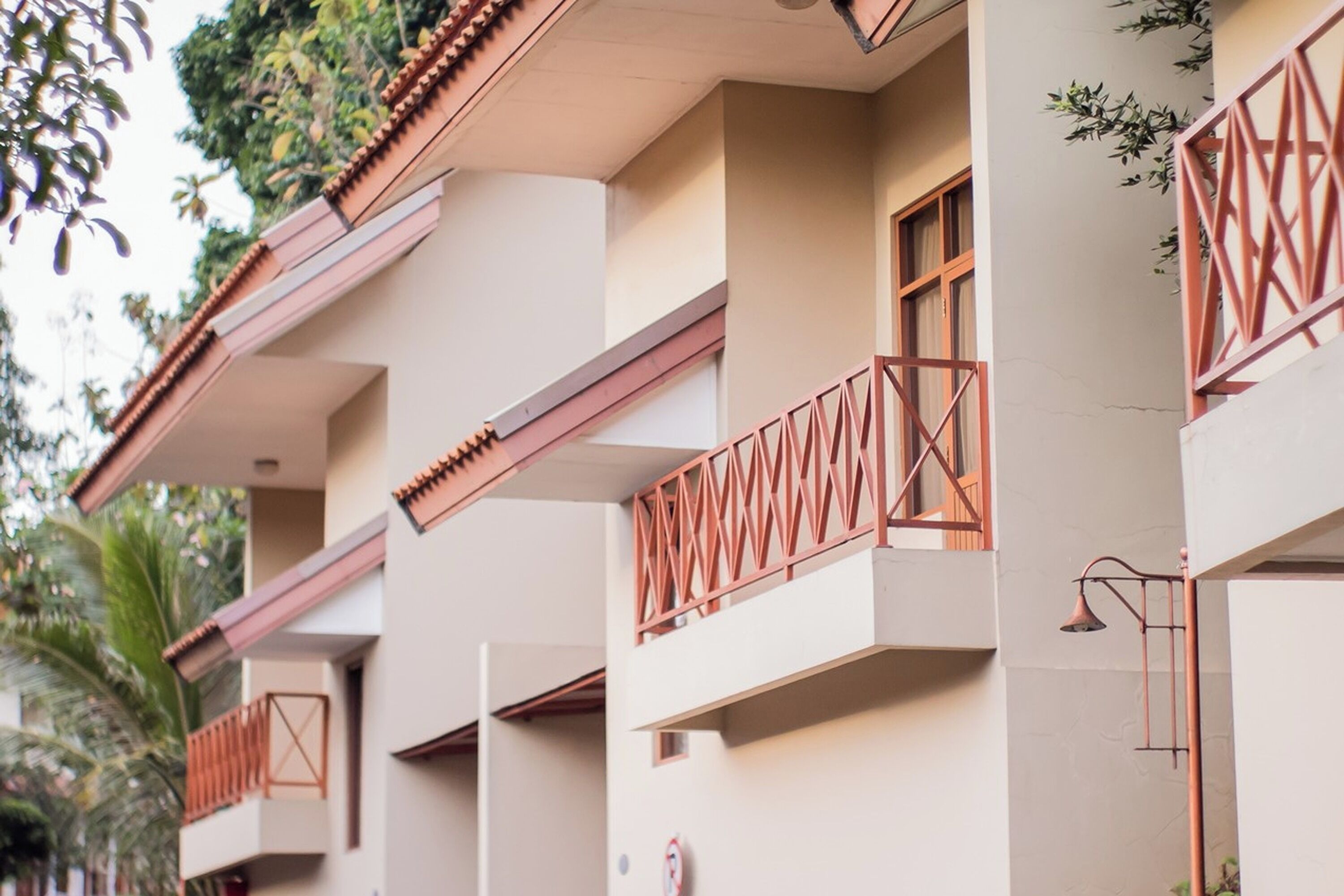 A multi-story building with balconies, a flat roof, and a simple, clean architectural style.