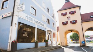 Hotellet "Hotel Kattenbeck" med stor indgang og blomsterkasser.