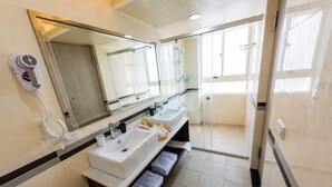 A modern bathroom with dual sinks, a large mirror, a hairdryer, and a shower area. - ManMan House (New Taipei City)