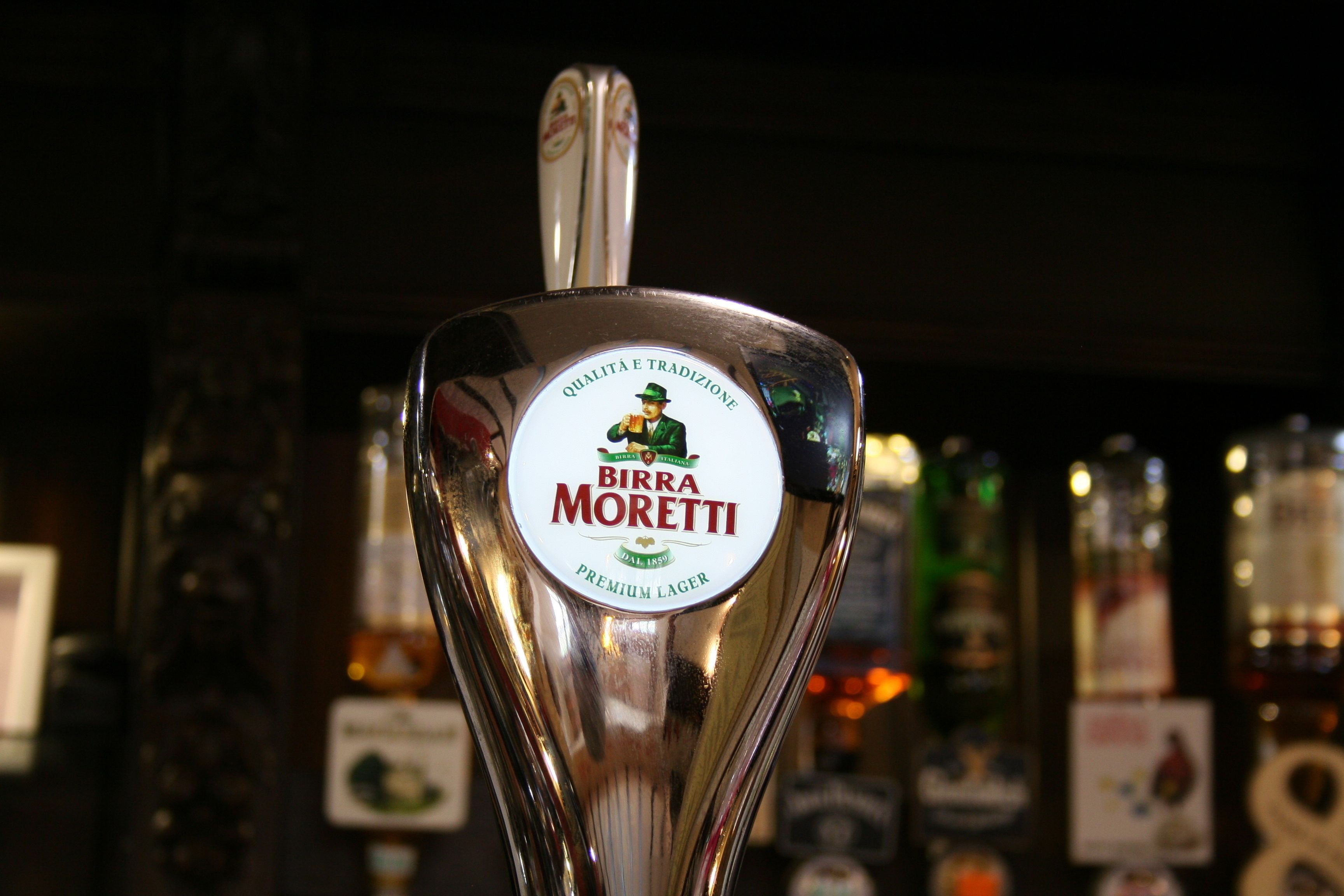 Une tireuse à bière portant l’inscription « Birra Moretti Premium Lager » et présentant un design traditionnel.