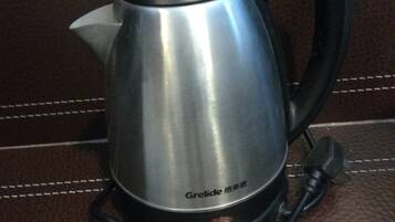 A Grelide electric kettle on a brown leather surface.