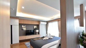 A modern hotel room with a large bed, a flat-screen TV, a desk, and a wardrobe. - The U-Time Hotel (Hat Yai)