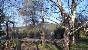 A park with a metal structure, trees, and a clear sky. - Whispering Spirit Holiday Cottages (Franklin)
