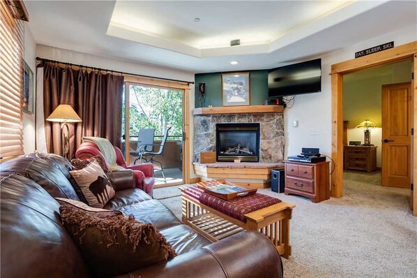 Flat-screen TV, fireplace, video game console