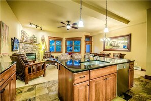 Flat-screen TV, fireplace, toys, books