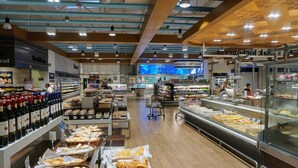 A bakery section with bread and pastries, a refrigerated display case, and a wine section with bottles. - Ocean Dream 1 Bedroom Condo (Cancun)