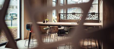 Un interior moderno con una mesa de madera, sillas y una planta decorativa.