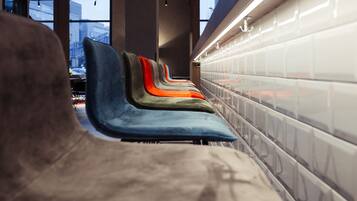 Comfortable seating areas face a grid-patterned wall, offering a relaxing space to unwind.