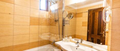 A bathroom with a bathtub, a sink, and a shower.