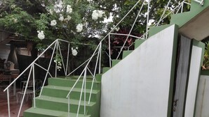 A staircase with green steps and white railings, leading to a door with a padlock. - Villa Isabel y Luisito (Viñales)
