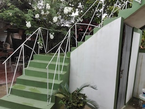 A staircase with green steps and white railings, leading to a door with a padlock. - Villa Isabel y Luisito (Viñales)