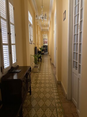 Stunning hallway leads to a dining area with a table set for four.