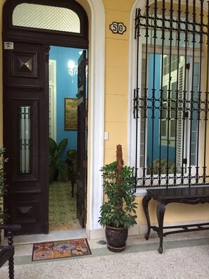 Welcome to the entrance of this charming building, featuring a door with a distinctive number '510' and a beautiful potted plant.