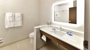 A modern bathroom with a white sink, a mirror, and two white towels hanging on the wall. - Holiday Inn Express & Suites Millersburg by IHG (Millersburg)
