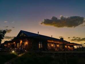 A stone building with large windows and a covered patio area. - Simbavati Cederberg Ridge (Cederberg)