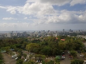 A cityscape with a mix of high-rise buildings and greenery. - 1209 Two Residences Marco Polo Cebu (Cebu City)