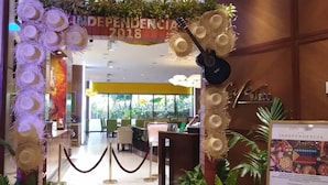 A hotel lobby with a reception desk, a decorative archway, and a sign indicating the hotel's name. - 1209 Two Residences Marco Polo Cebu (Cebu City)