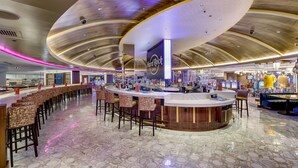 A Hard Rock Cafe with a curved ceiling, bar area with stools, and arcade games. - Hard Rock Hotel & Casino Atlantic City (Atlantic City)