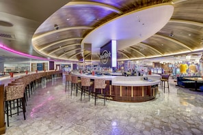 A Hard Rock Cafe with a curved ceiling, bar area with stools, and arcade games. - Hard Rock Hotel & Casino Atlantic City (Atlantic City)