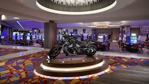 A casino with a large, centrally placed motorcycle, multiple gaming machines, and a distinctive chandelier. - Hard Rock Hotel & Casino Atlantic City (Atlantic City)