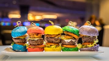 A tray of colorful burgers with a blurred background.