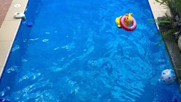 Outdoor pool, open 8 AM to 9 PM, pool umbrellas, pool loungers