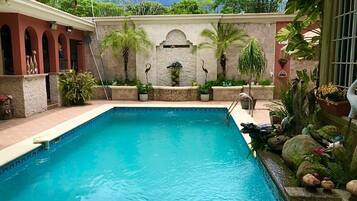 Outdoor pool, open 8 AM to 9 PM, pool umbrellas, pool loungers