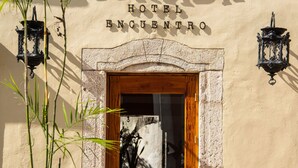The exterior of Verde Morada Hotel with a wooden door and a sign above it. - Verde Morada Hotel Encuentro (Valladolid)