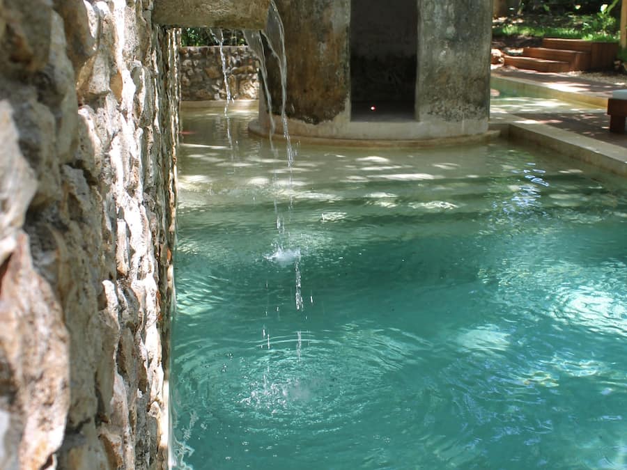 Una piscina al aire libre, sillones reclinables de piscina