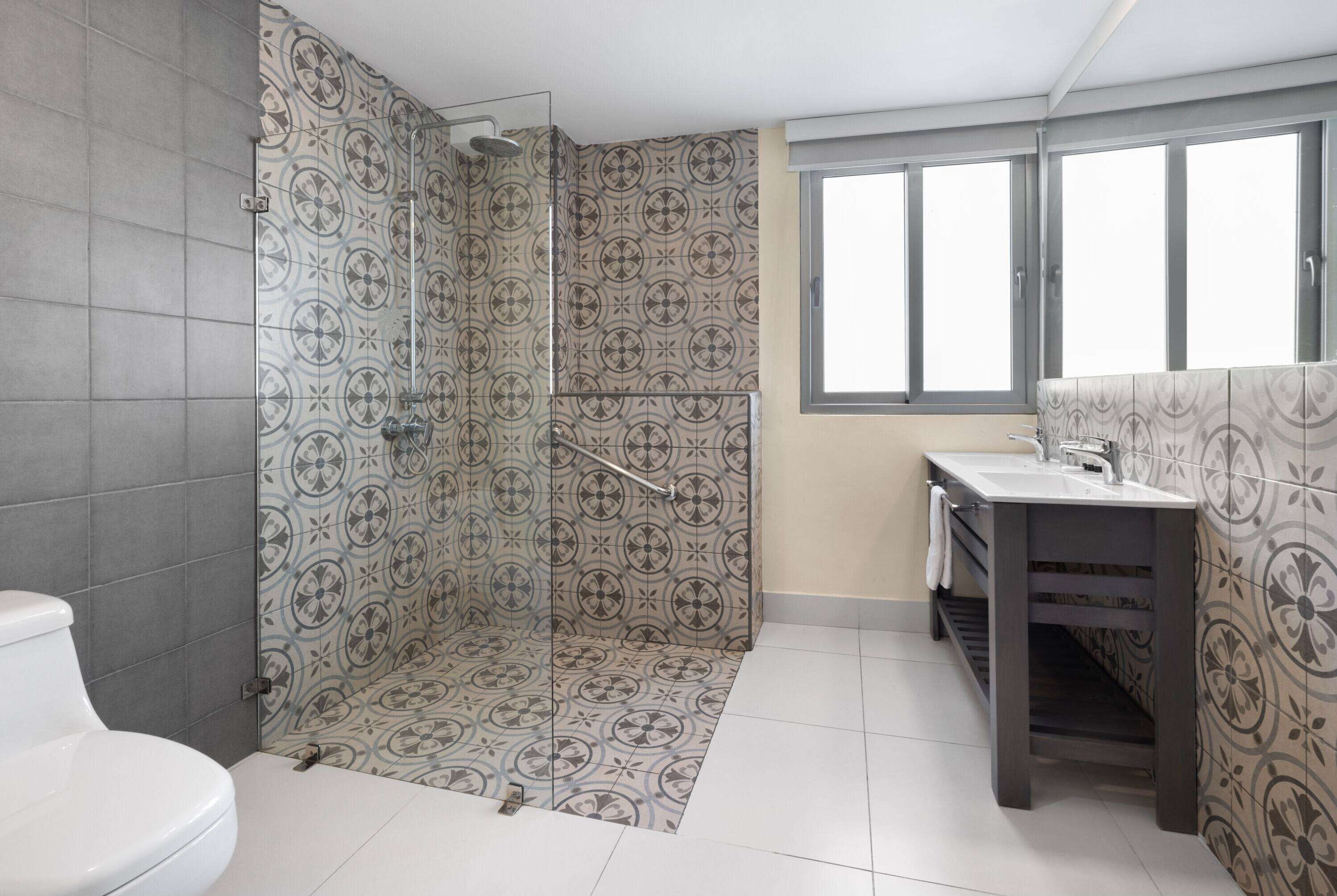 A bathroom with a shower, toilet, and sink.