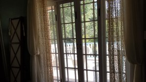 A room with a large glass door leading to an outdoor area.