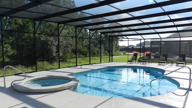 A covered swimming pool with a hot tub, surrounded by lounge chairs and a pergola. - Sm215701 - Watersong - 5 Bed 4 Baths Villa (Davenport)