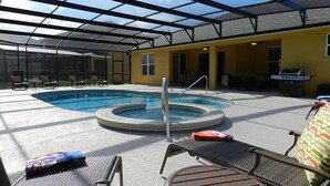 A pool area with a hot tub, lounge chairs, and a grill. - Sm215701 - Watersong - 5 Bed 4 Baths Villa (Davenport)