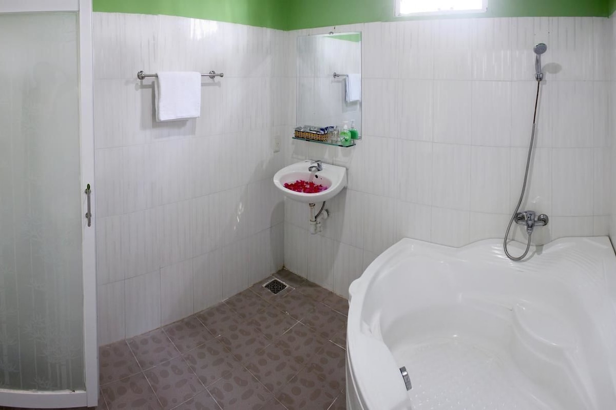 A bathroom with a shower, sink, and bathtub.