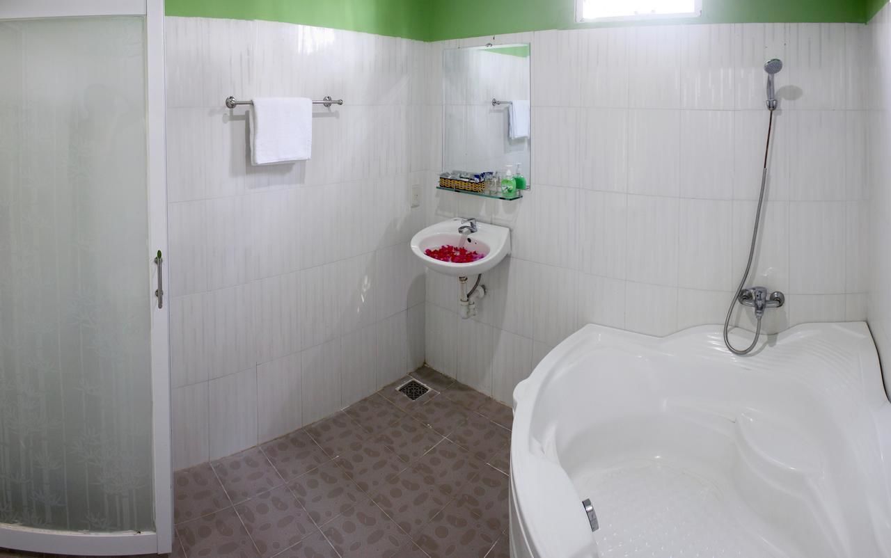 A bathroom with a shower, sink, and bathtub.