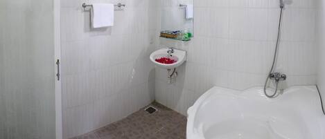 A bathroom with a shower, sink, and bathtub.