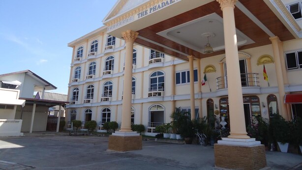 A multi-story building with a prominent entrance, columns, and a sign reading "THE PHADAENG". - Phadaeng Hotel (Ubon Ratchathani)