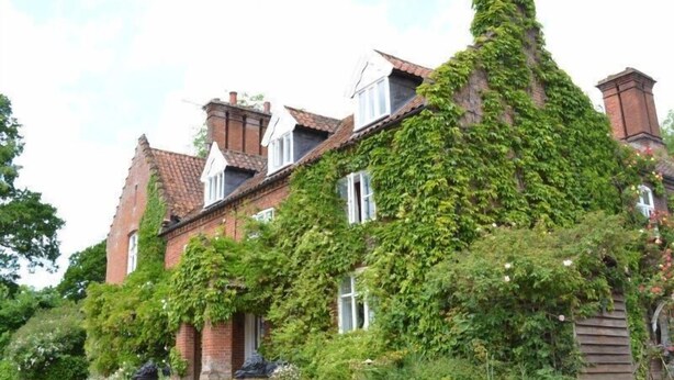A traditional brick house with ivy-covered walls and multiple chimneys. - Carrick's At Castle Farm (Dereham)